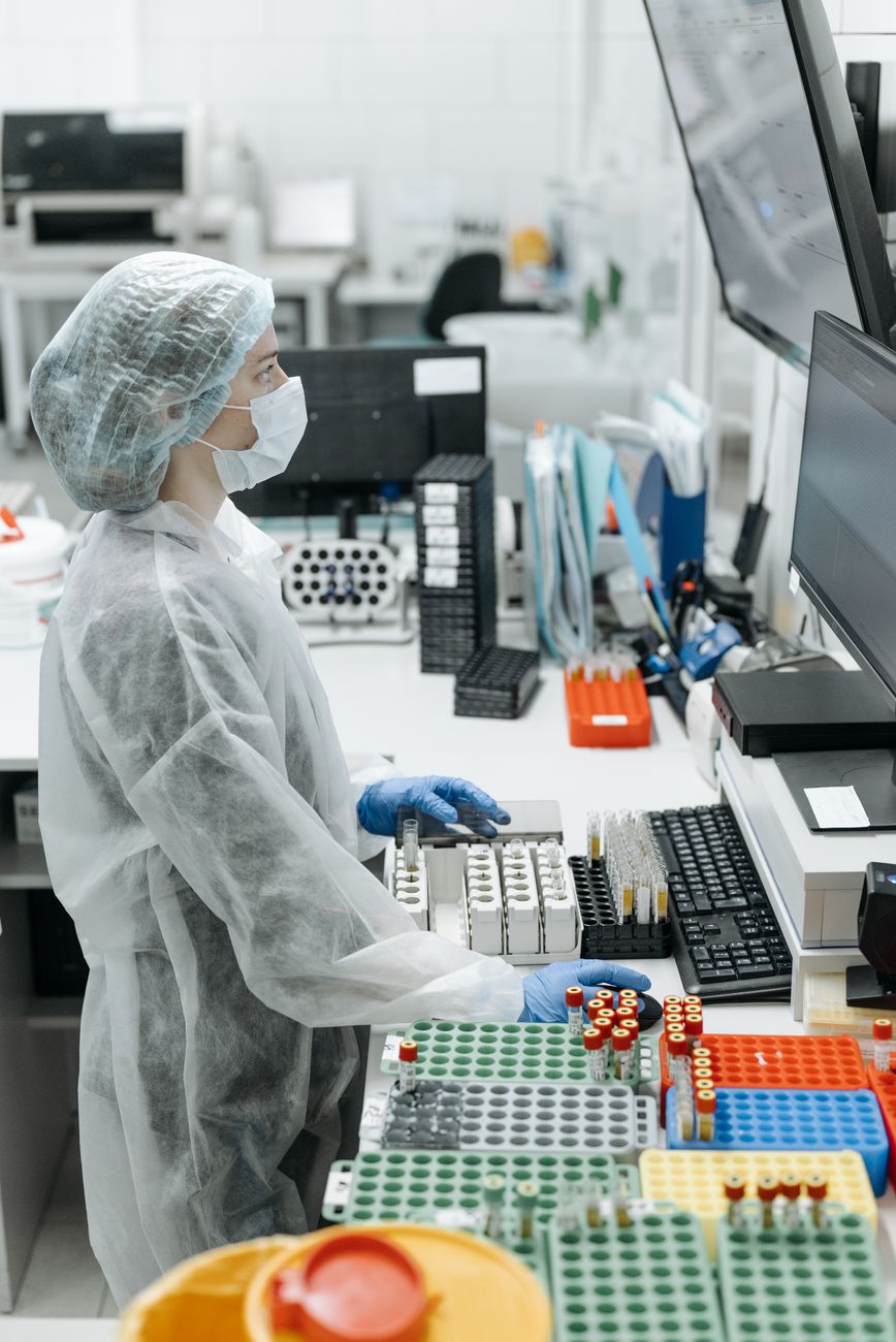 scientist using a computer and test tubes in a laboratory