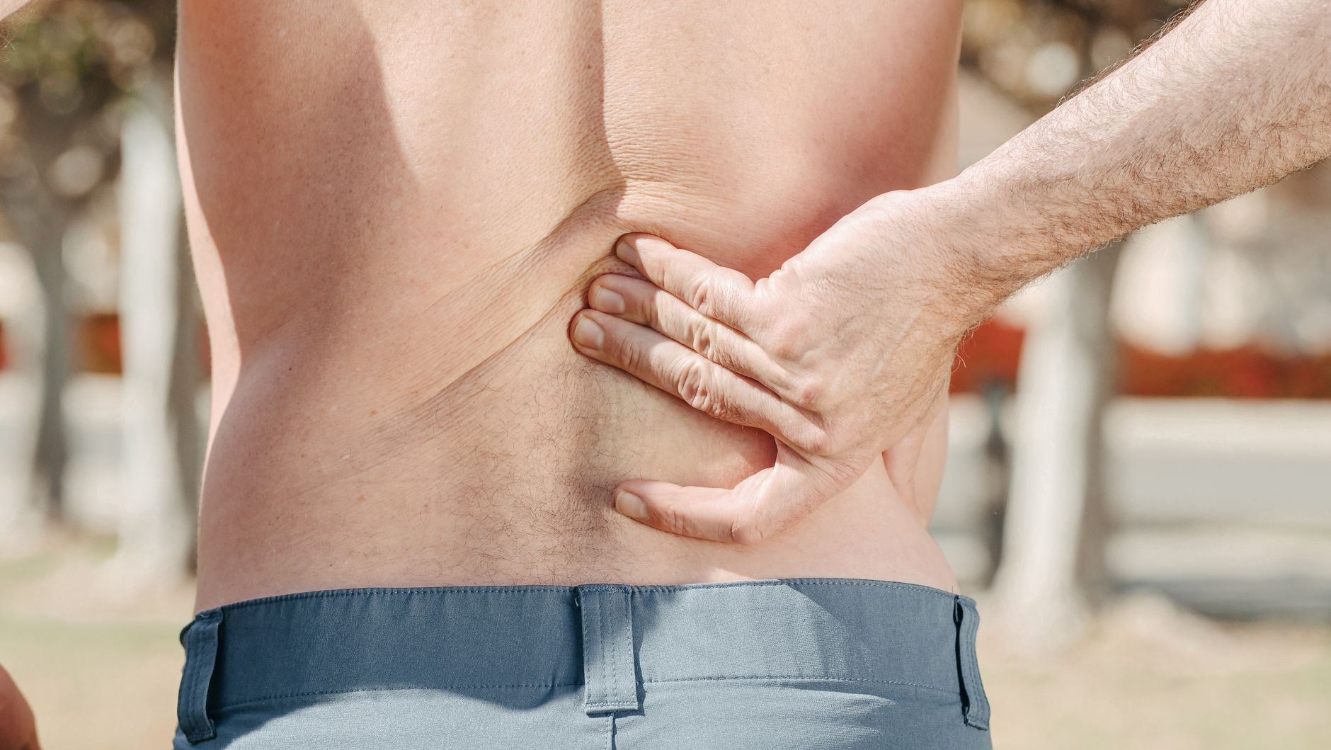 a man touching his back